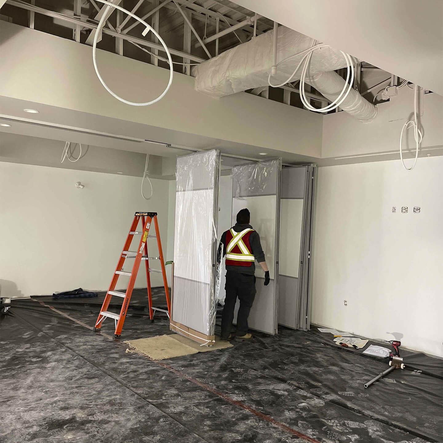 Contractors placing doors on a building's floor under construction