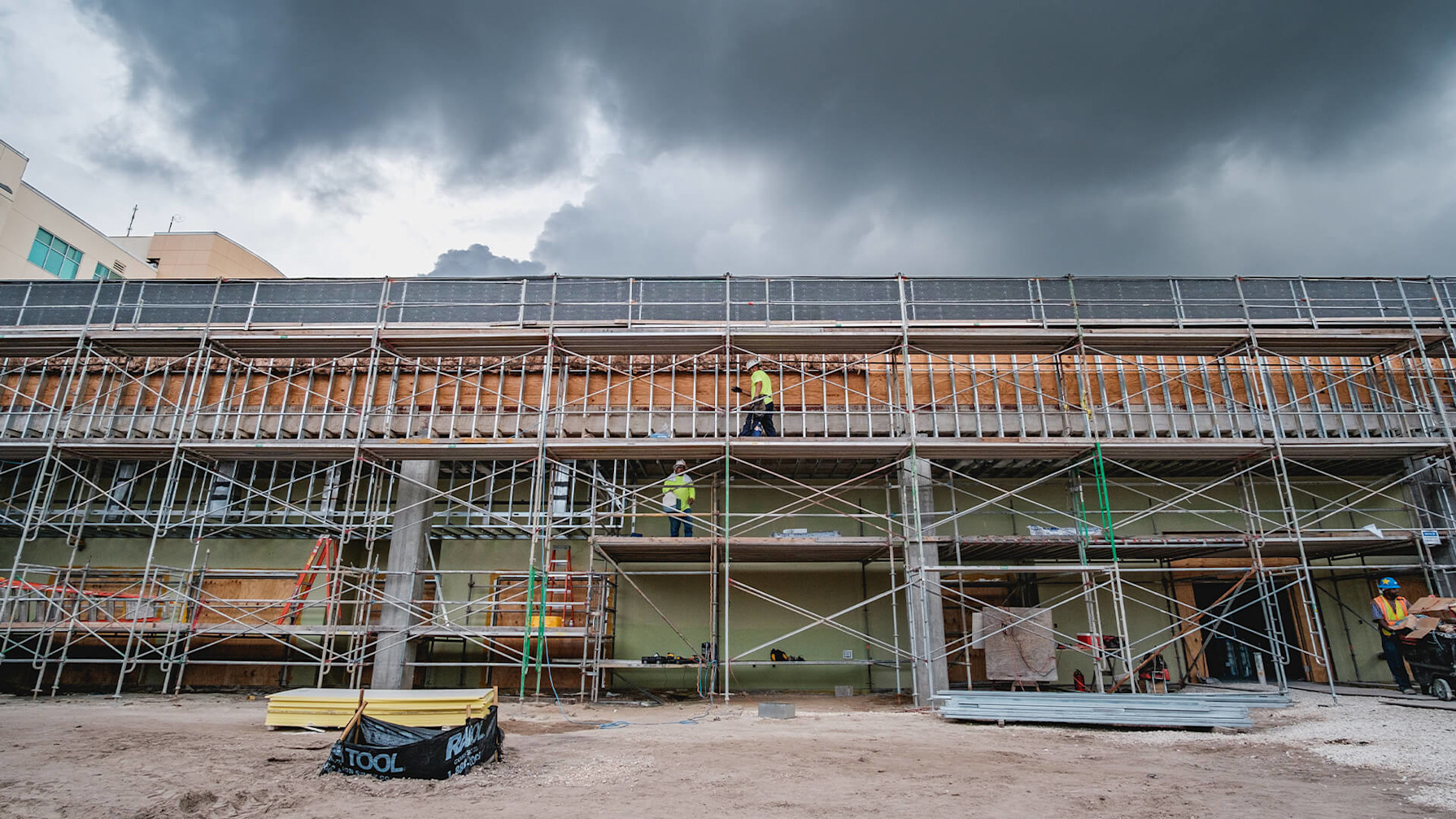 A construction site with scaffolding and workers