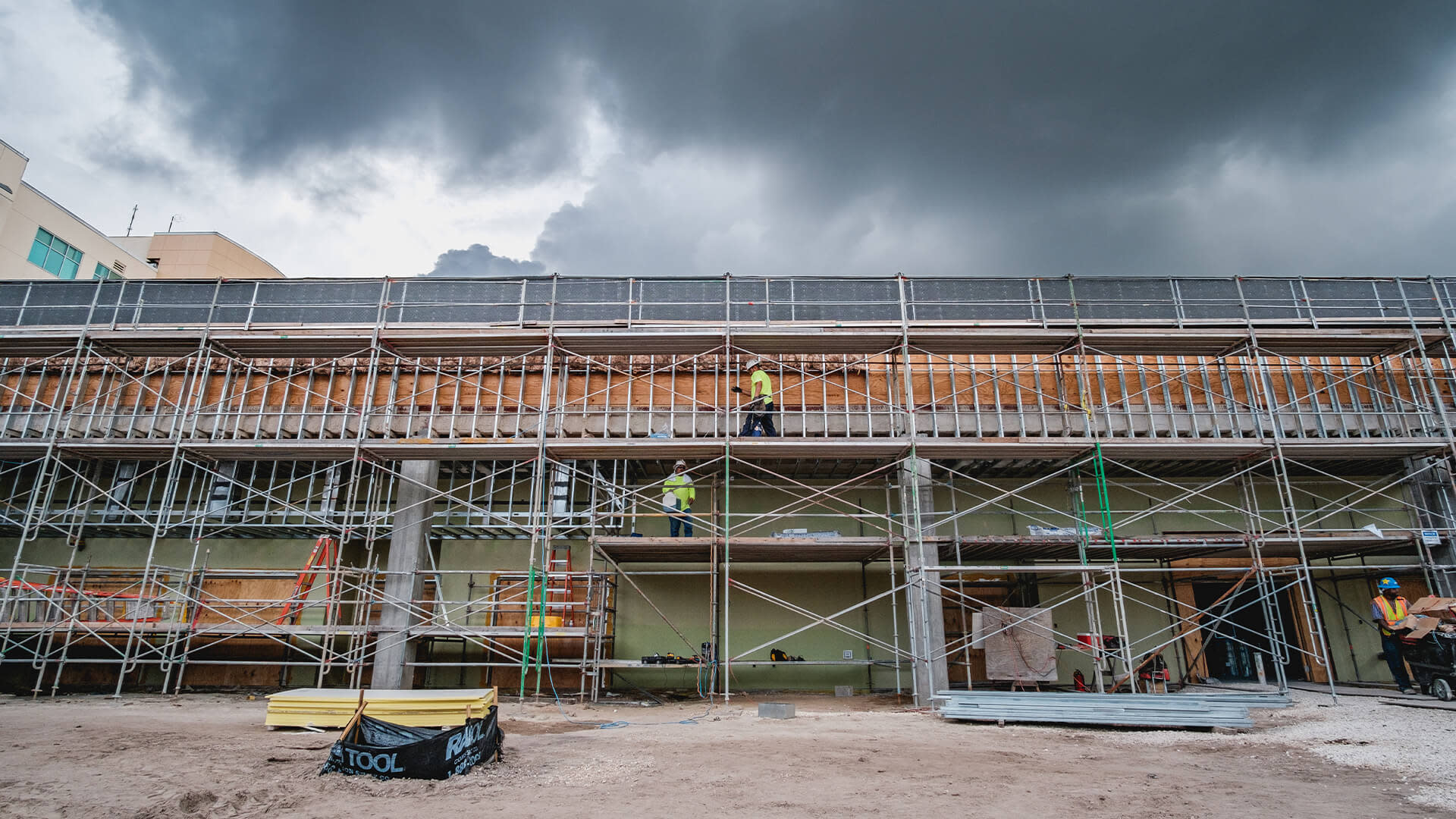 A construction site with scaffolding and workers