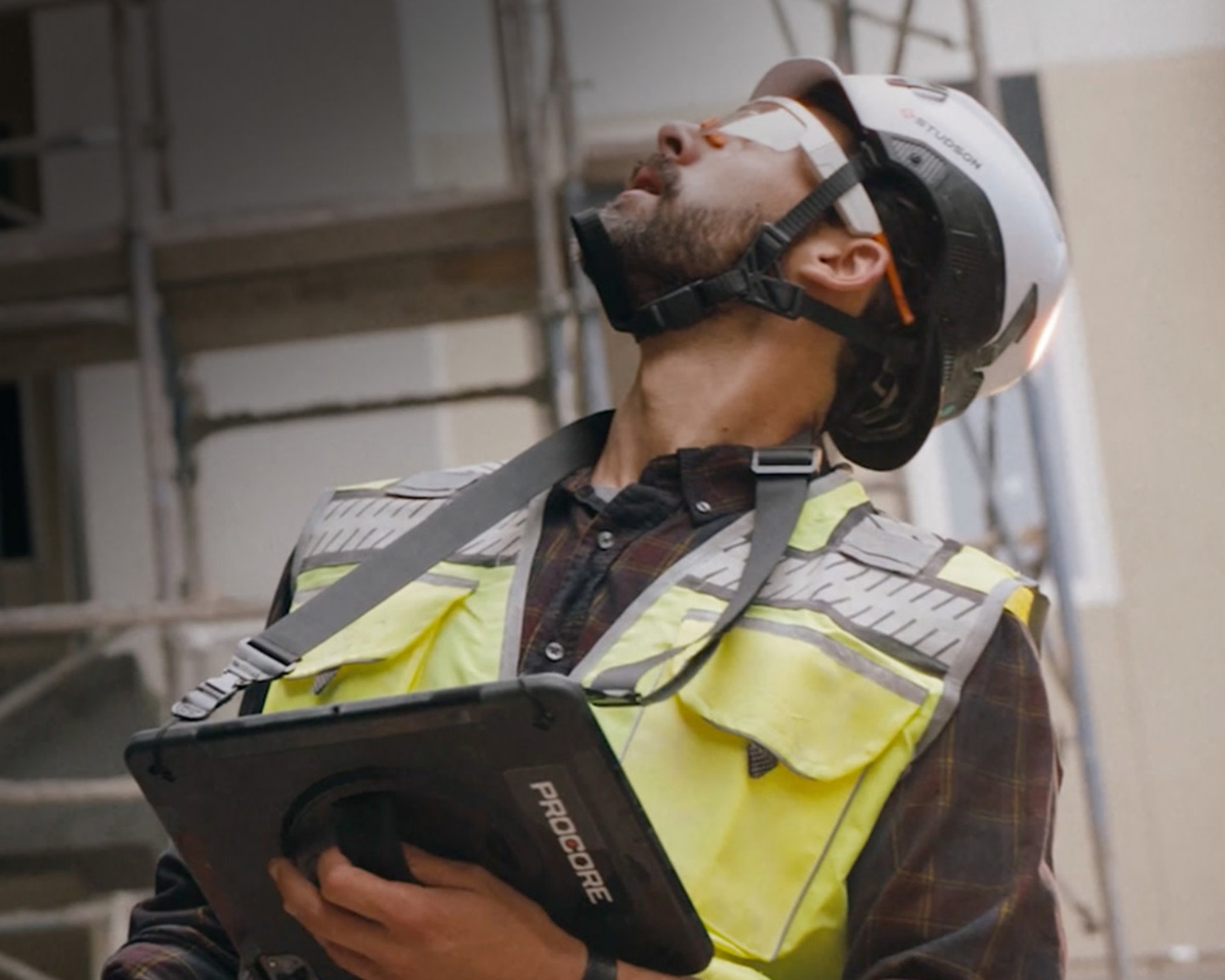 A contractor looking up at a construction site