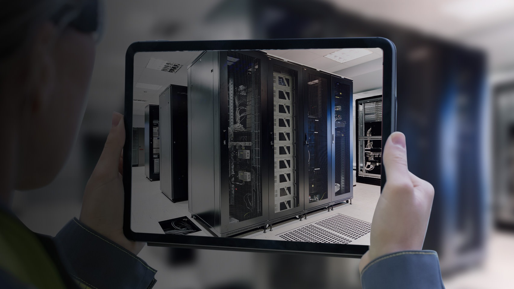 Woman taking a picture of a data center's servers with a tablet