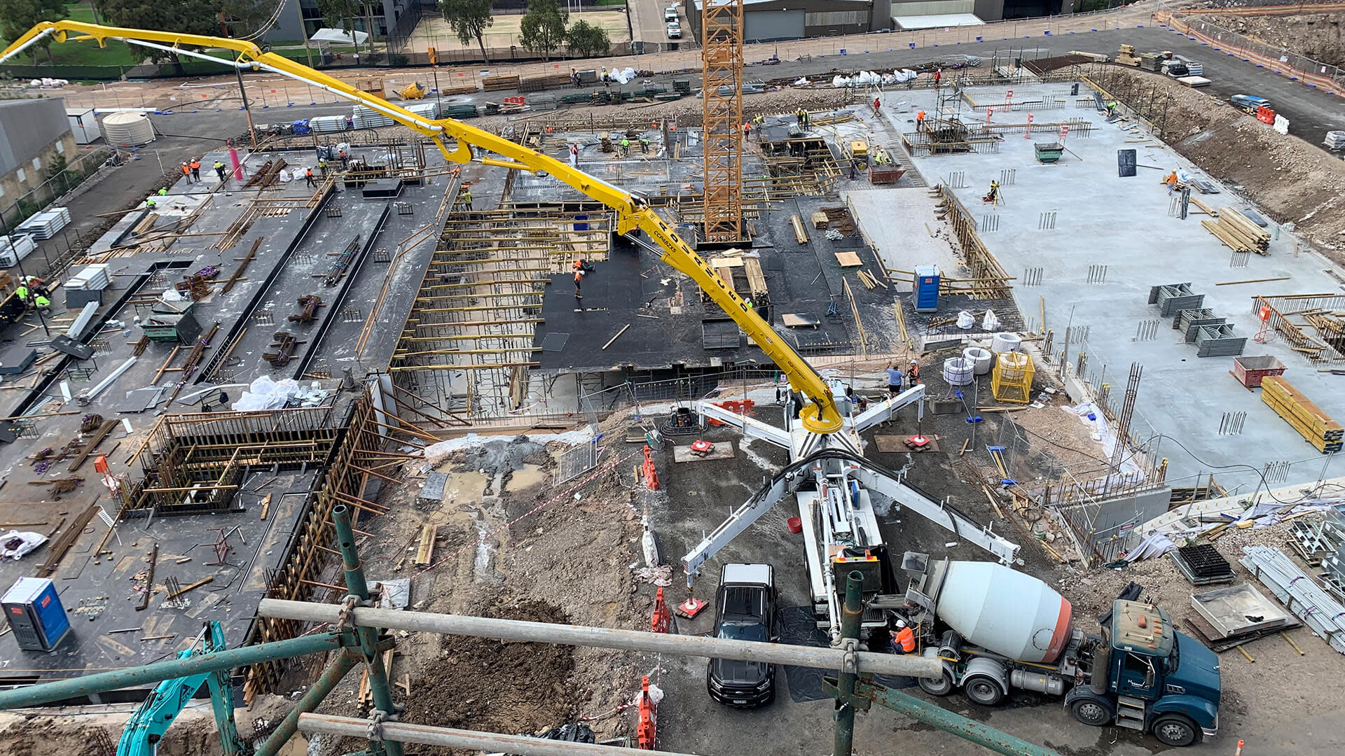 Birdseye view of a construction site with a large crane in the middle