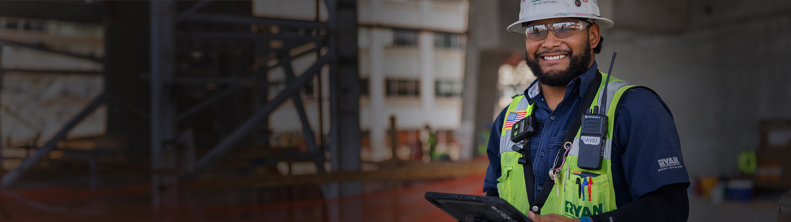 A man using a tablet at a construction site