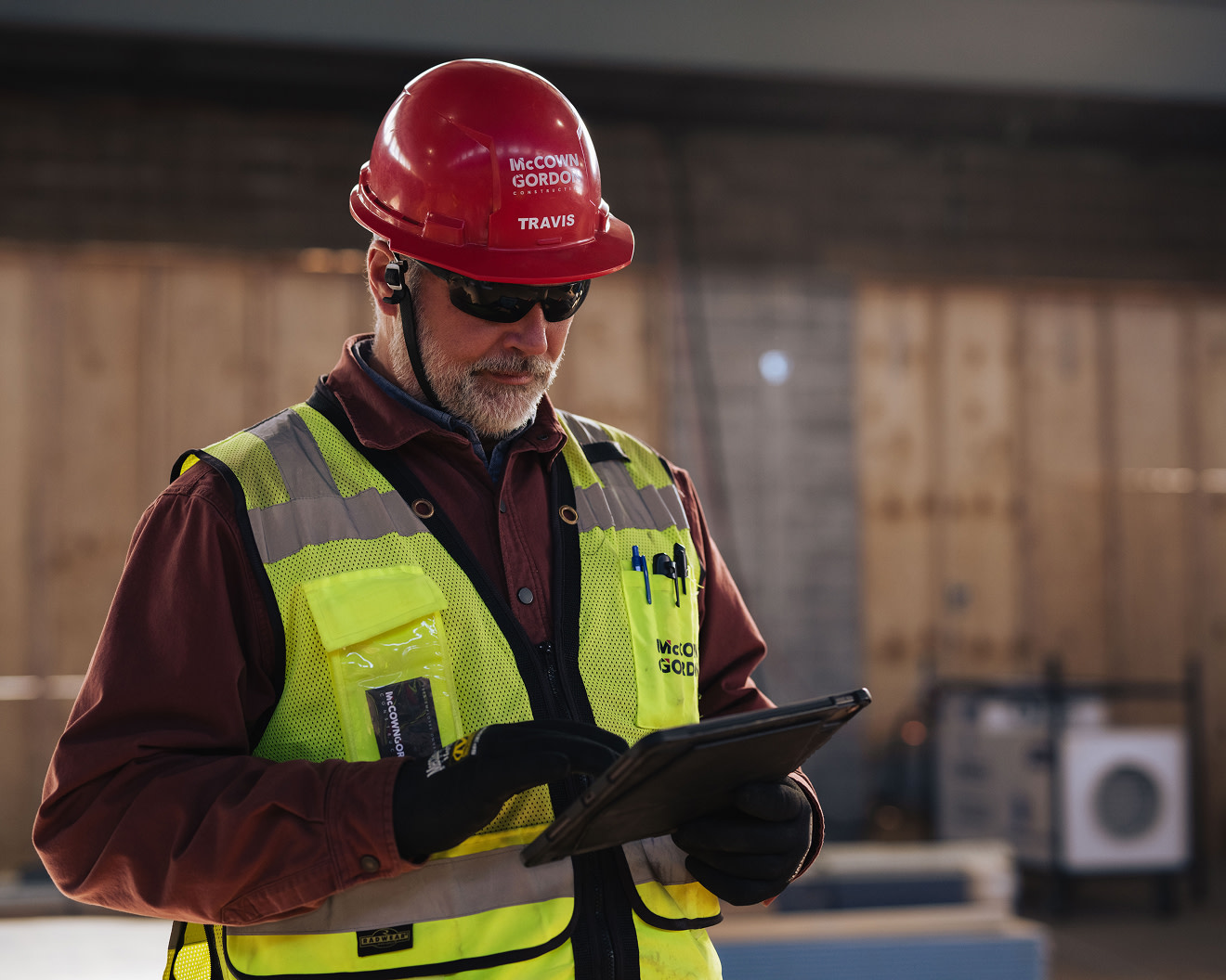 A construction worker using a tablet on site