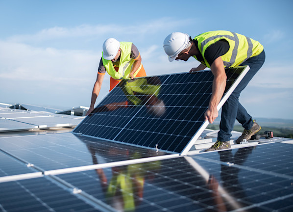 Construction workers setting up solar panels