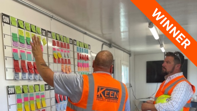 Keen contractors adding post its to a wall