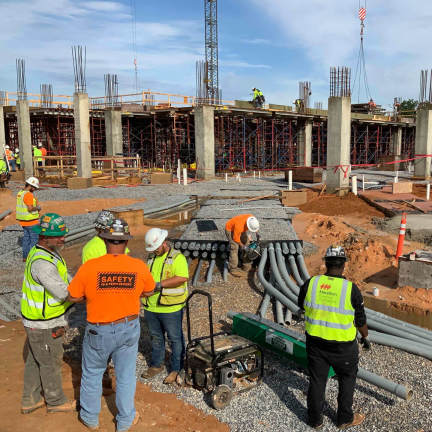 Construction workers installing cables on site