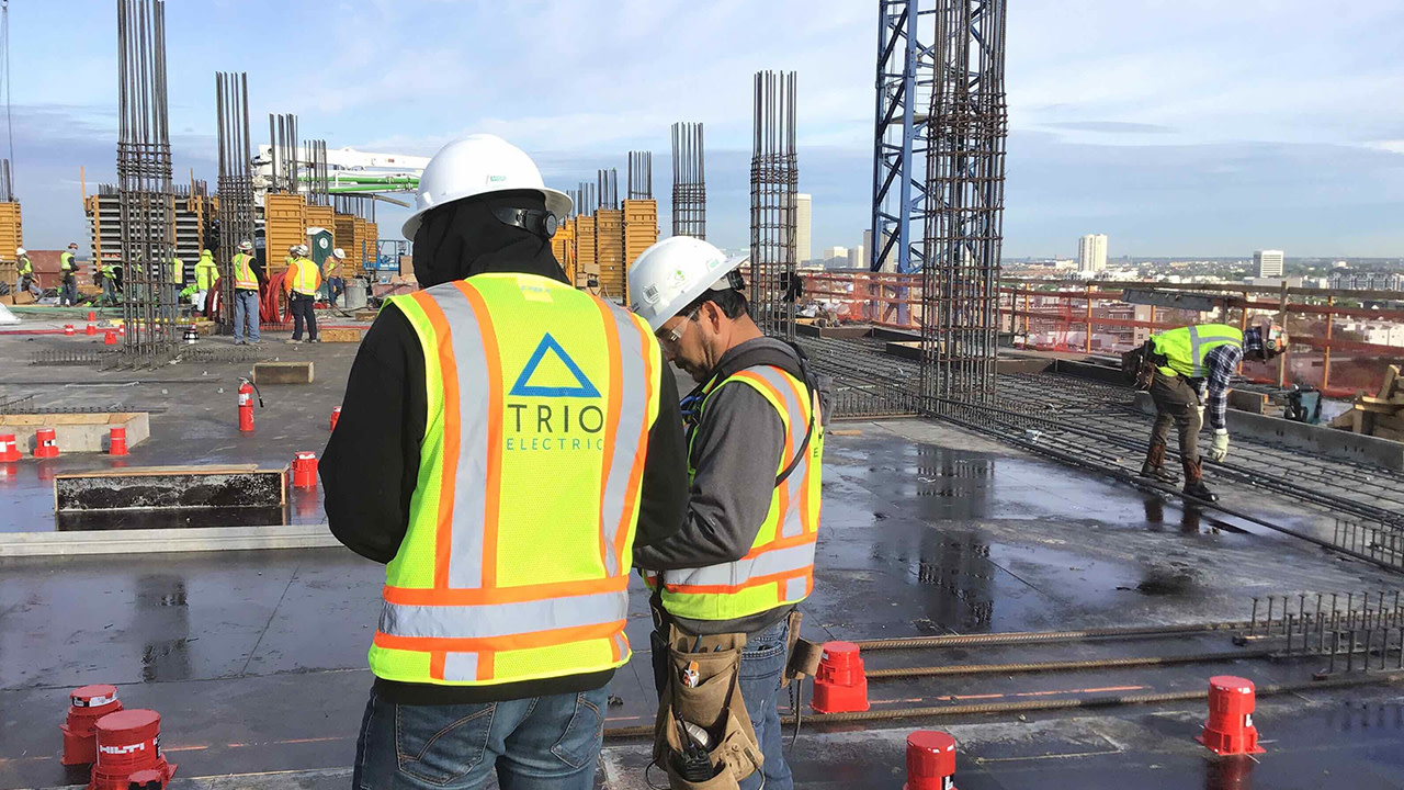 TRIO Electric construction workers finishing up a floor