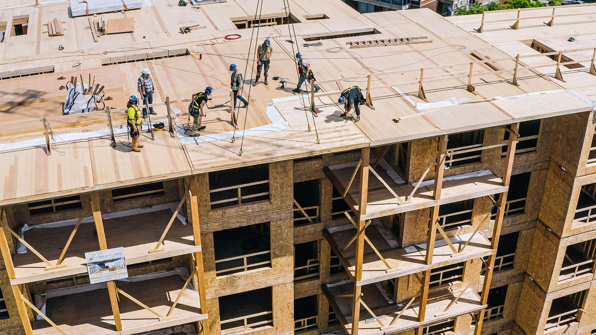 Construction workers standing on top of a building