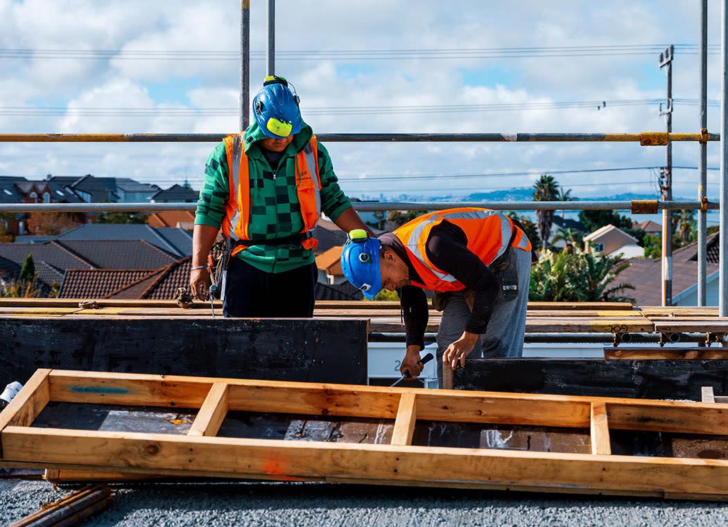 Construction workers hammering wood