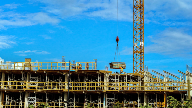 A crane moving pieces at a construction site