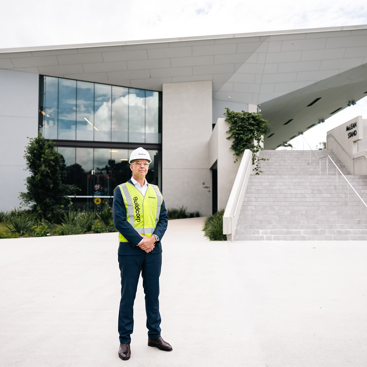 A woman contractor taking a picture of a construction site on her phone