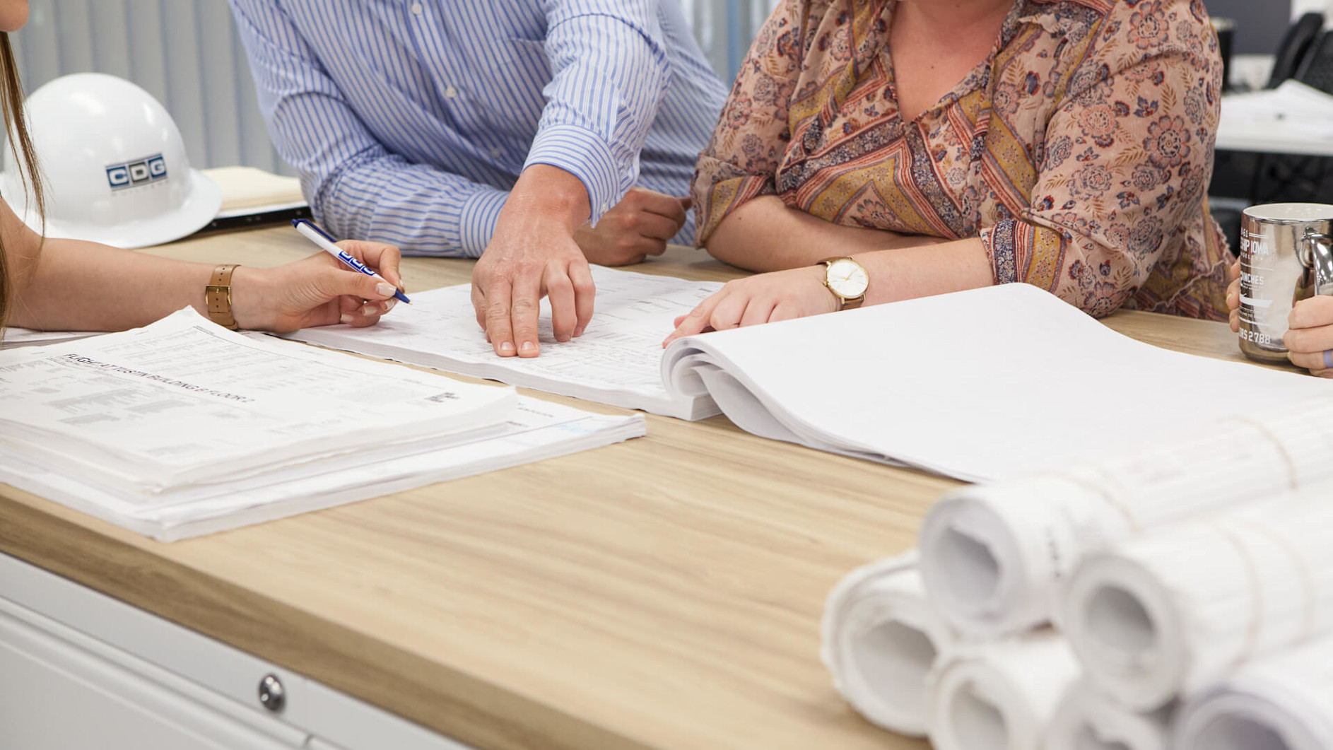 Close up of people working at a desk