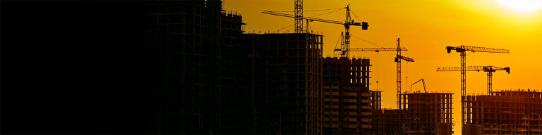 City skyline with construction cranes