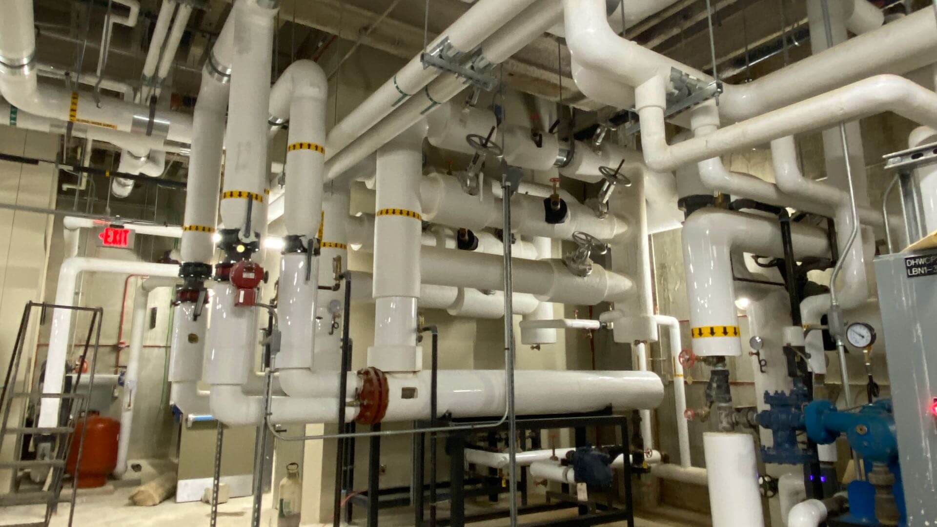Interior of mechanical room with large maze like pipes