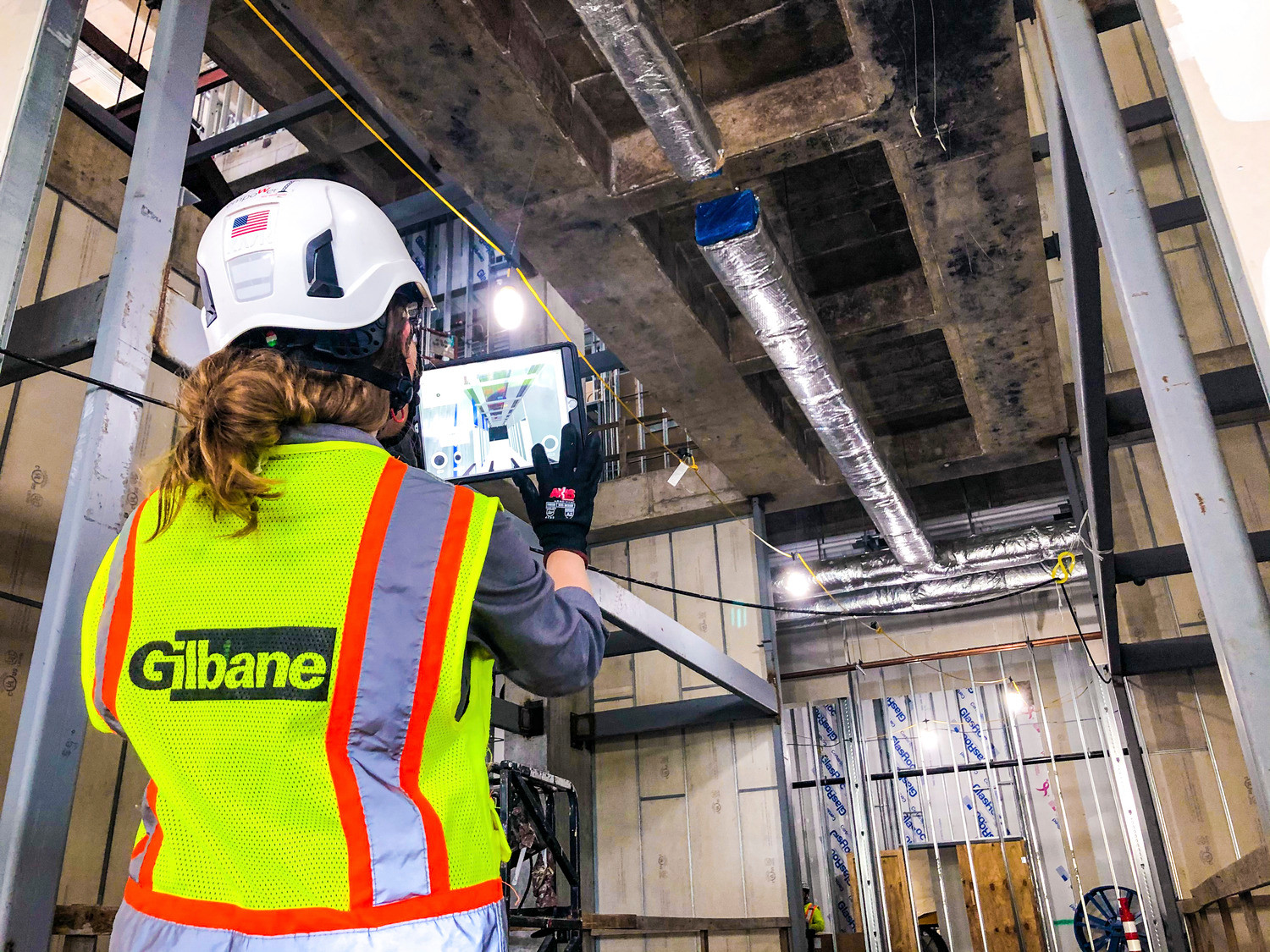 Gilbane employee on project with iPad