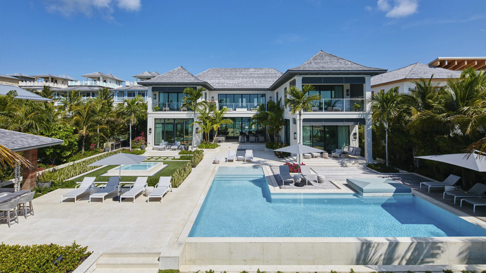 Two story glass home's pool area