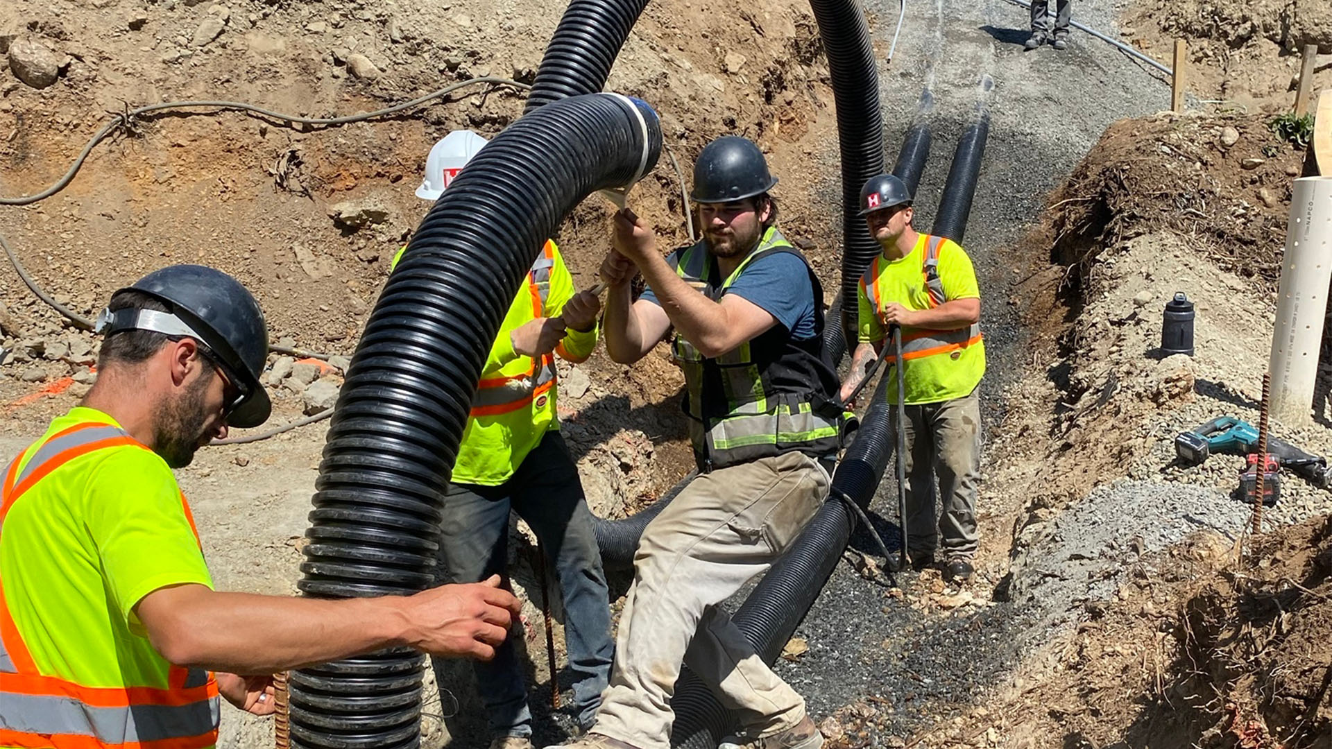 a group of men working on a pipe