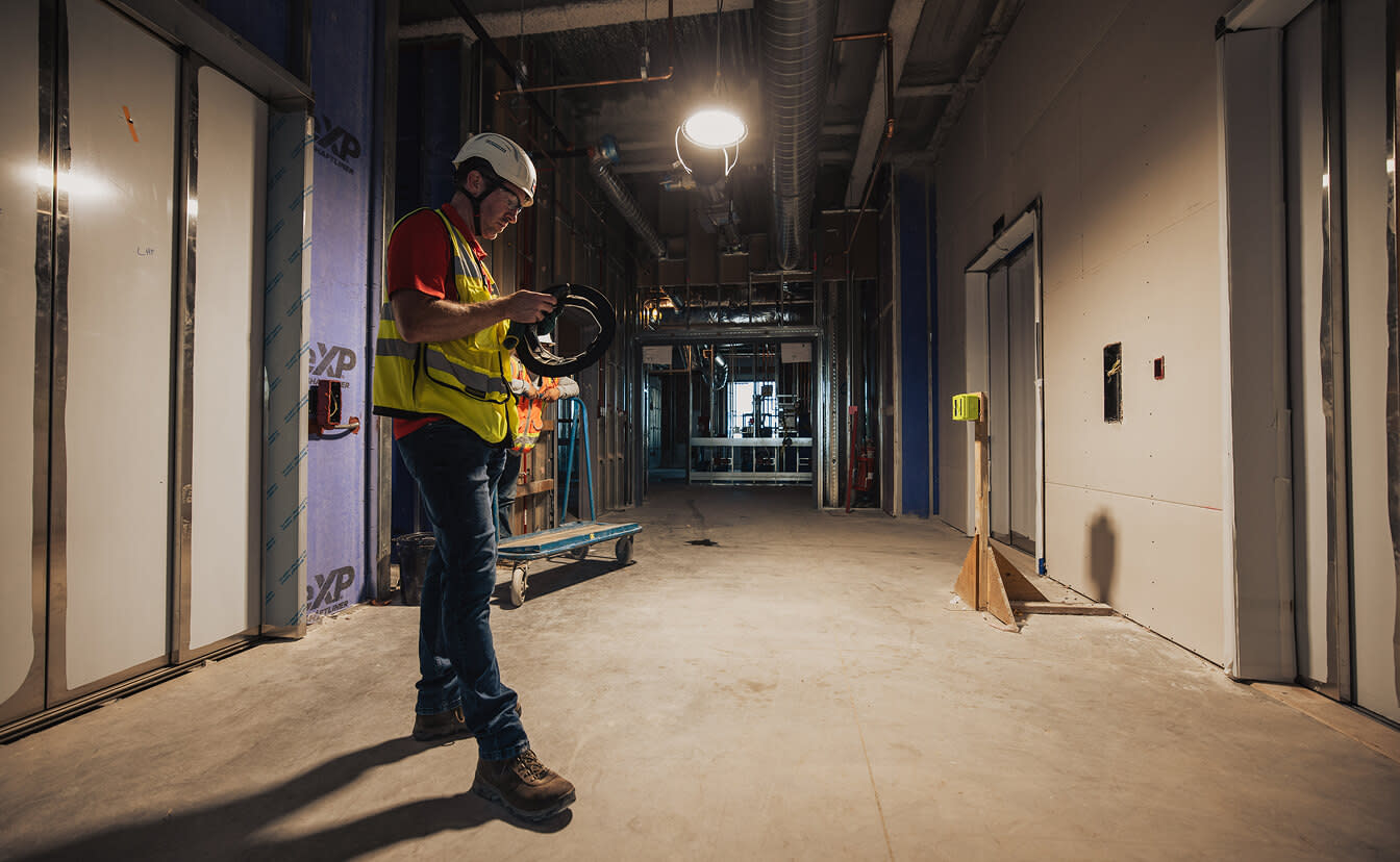 A contractor standing at a building construction
