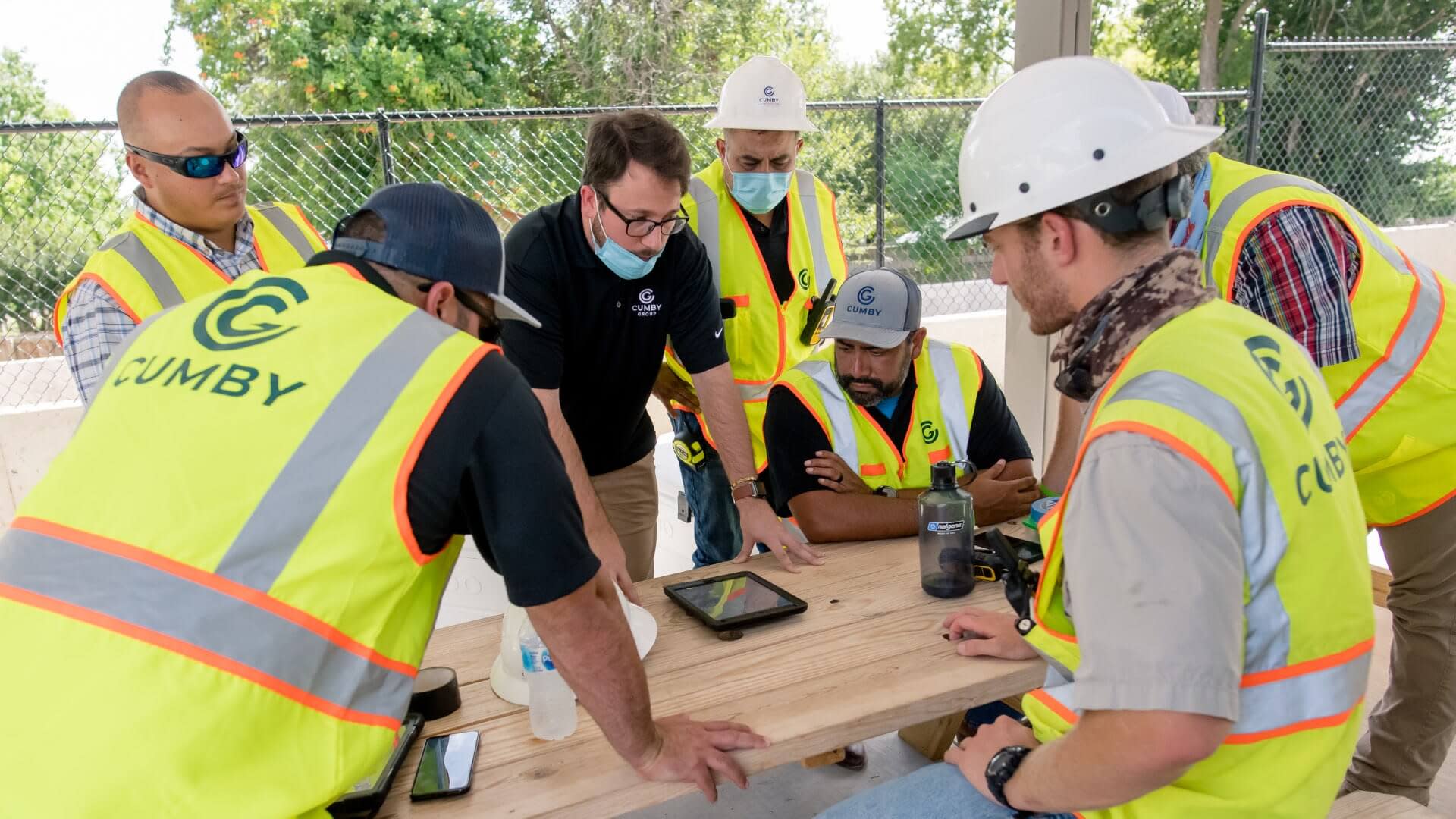 Cumby Group discussing plans on a jobsite