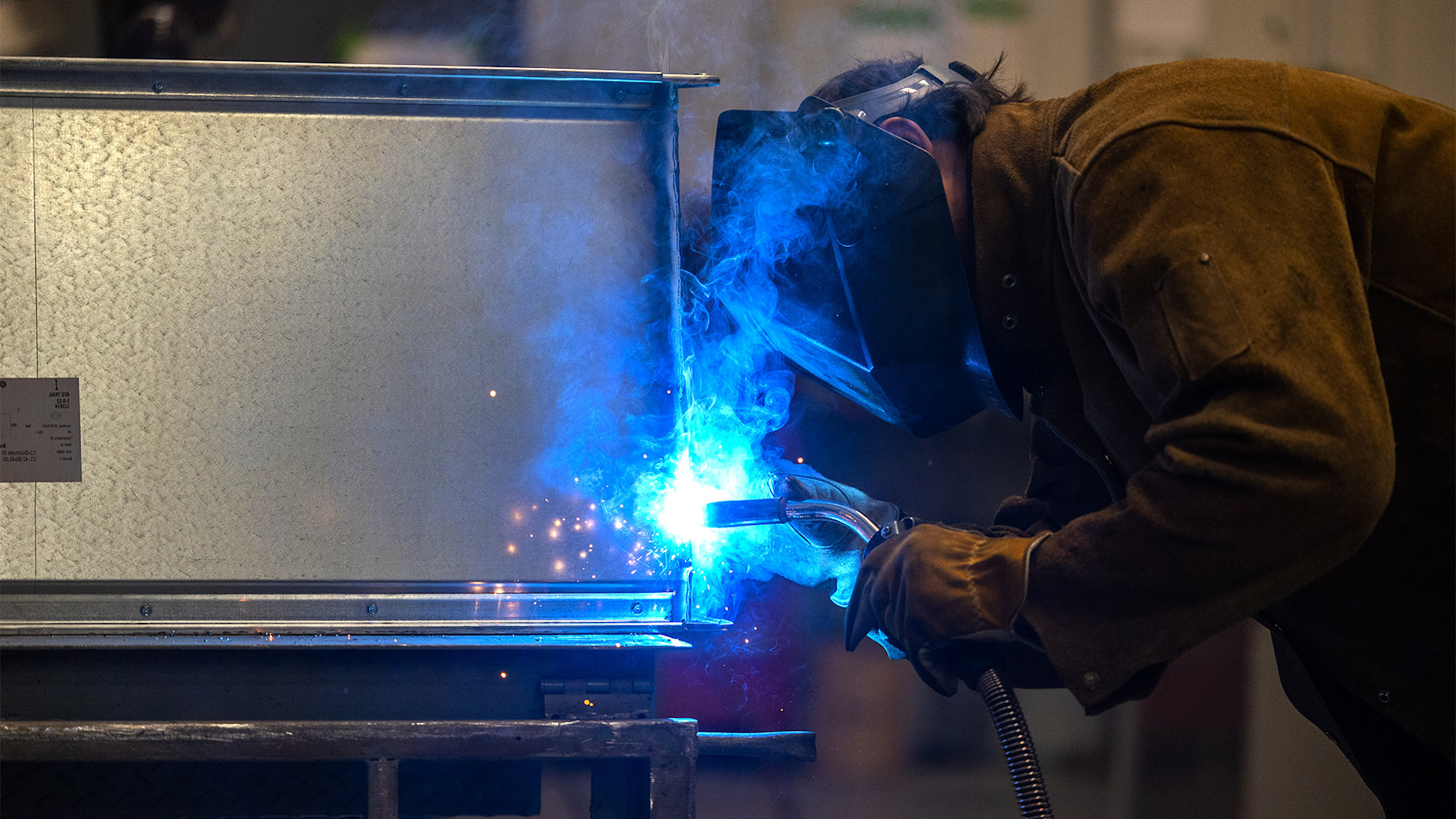 A man welding a metal piece
