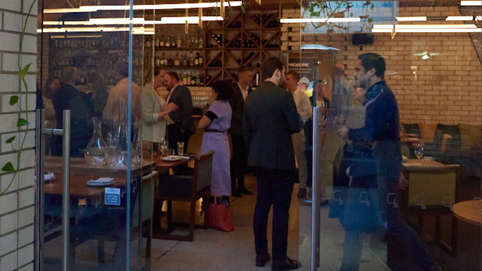 A group of people standing around a restaurant