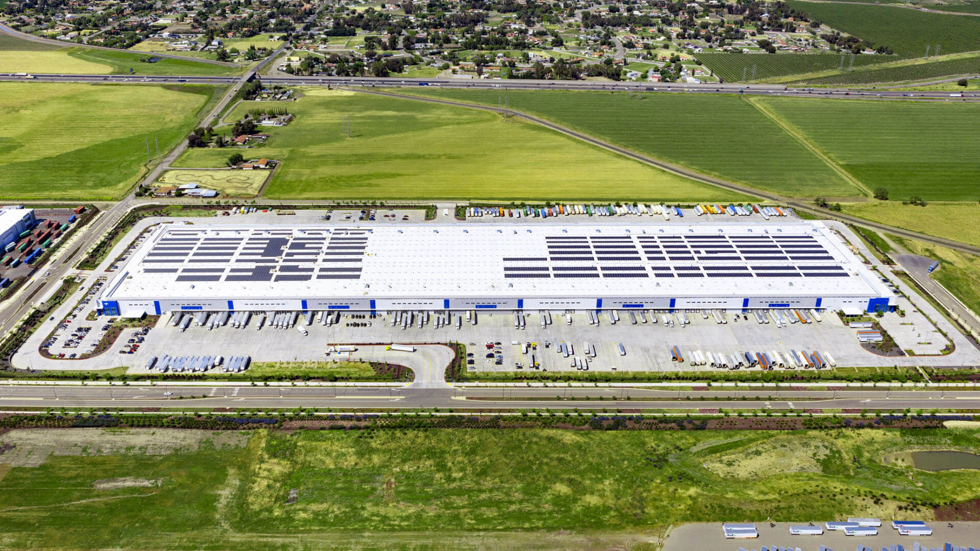 A warehouse with solar panels on its roof