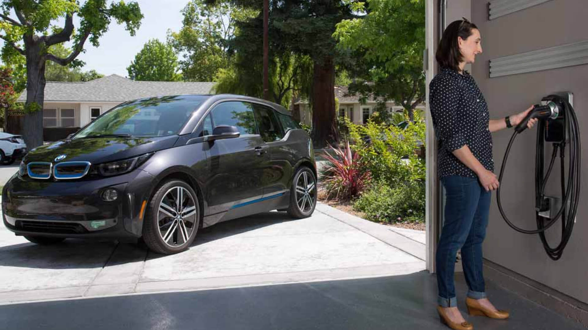 Woman taking out the charging cable on her garage