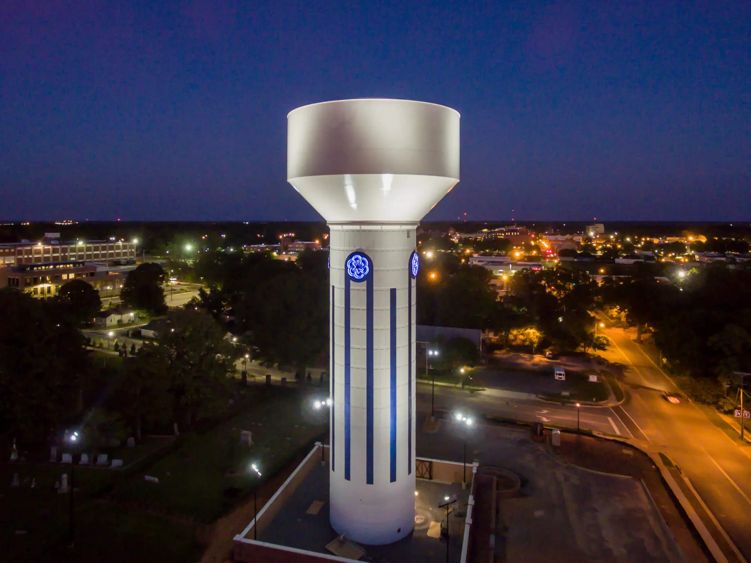 A water tower lit up during night time