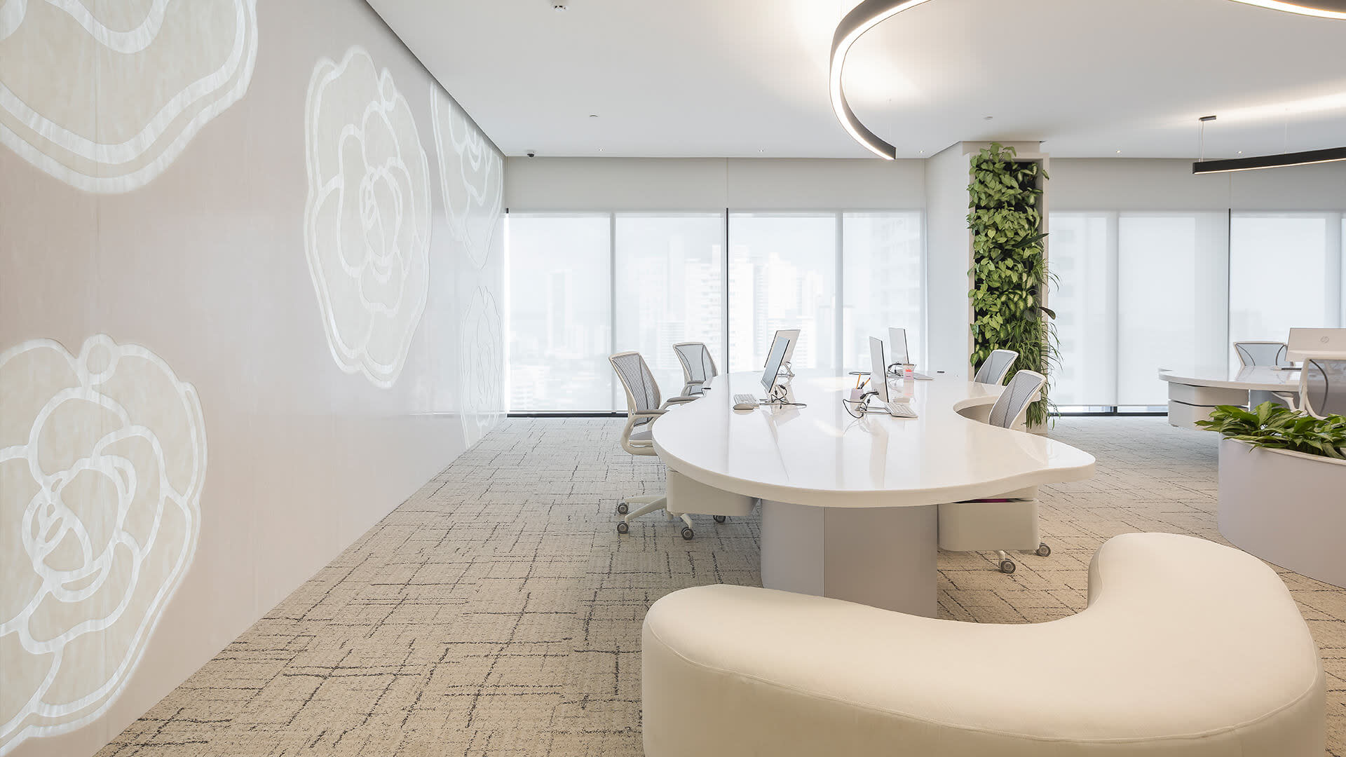 An all white office space with a vertical garden