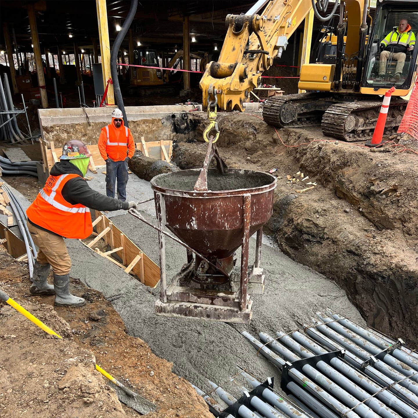 Construction workers pouring down cement