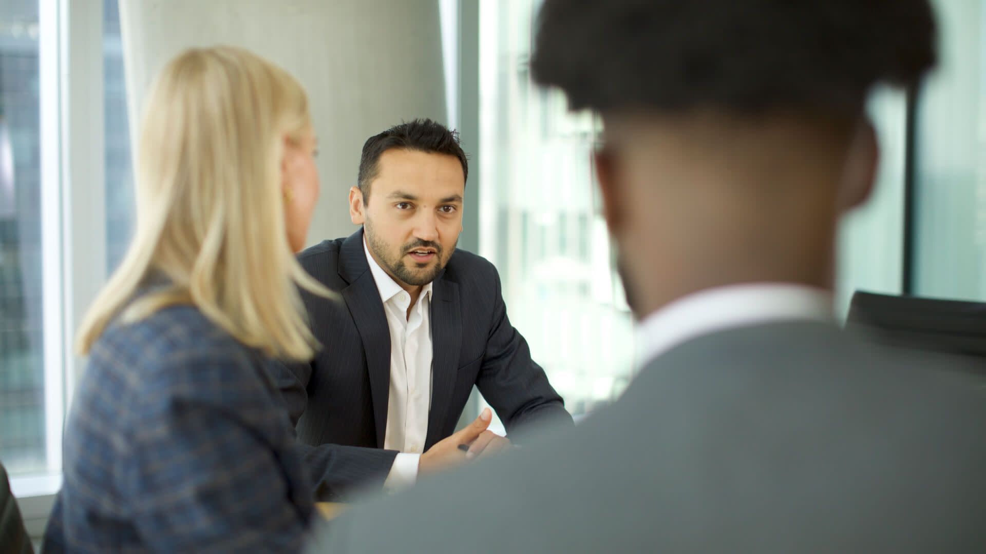 People in a meeting room discussing the plans