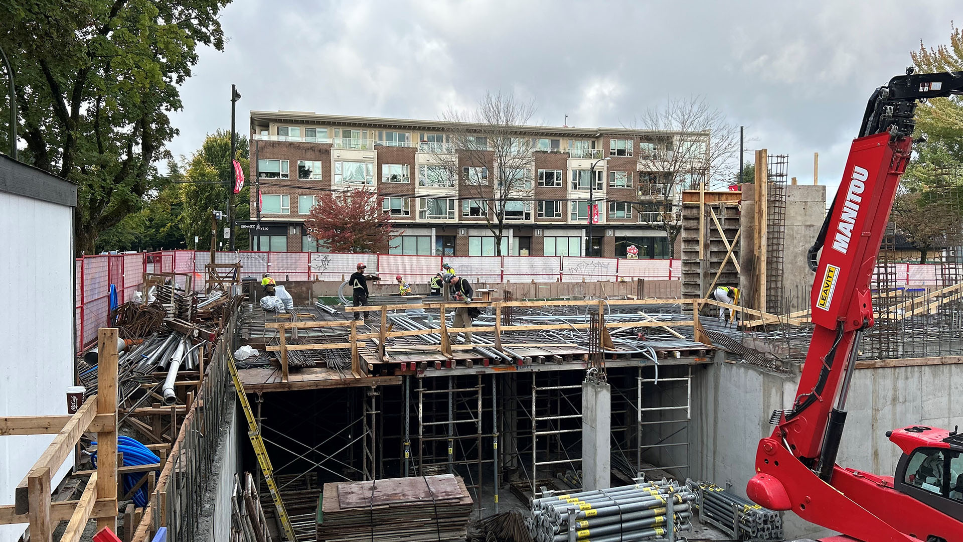 a construction site with people working on the ground