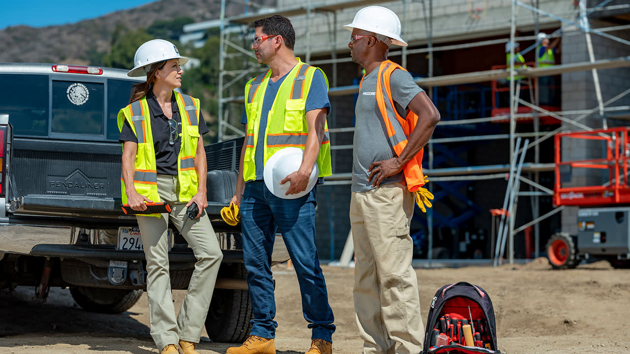 Three construction workers on site