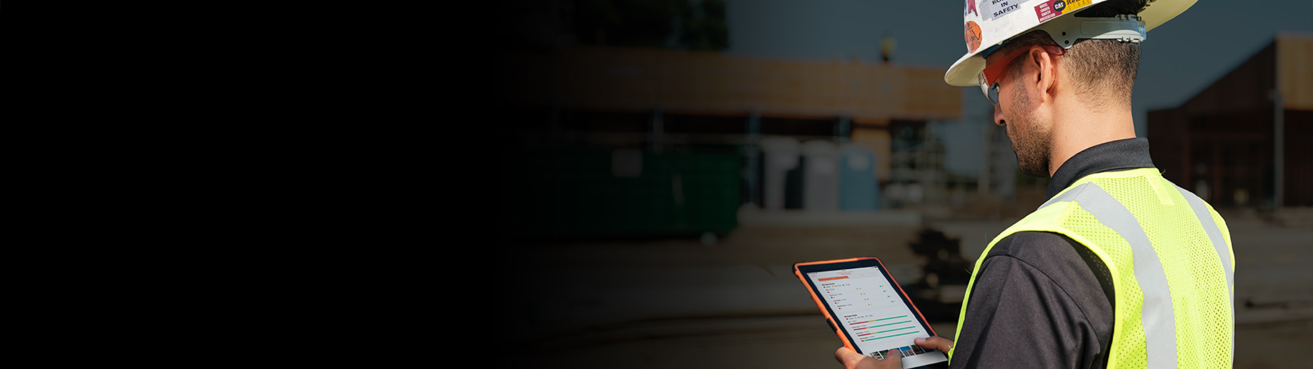 A contractor using a tablet on a construction site