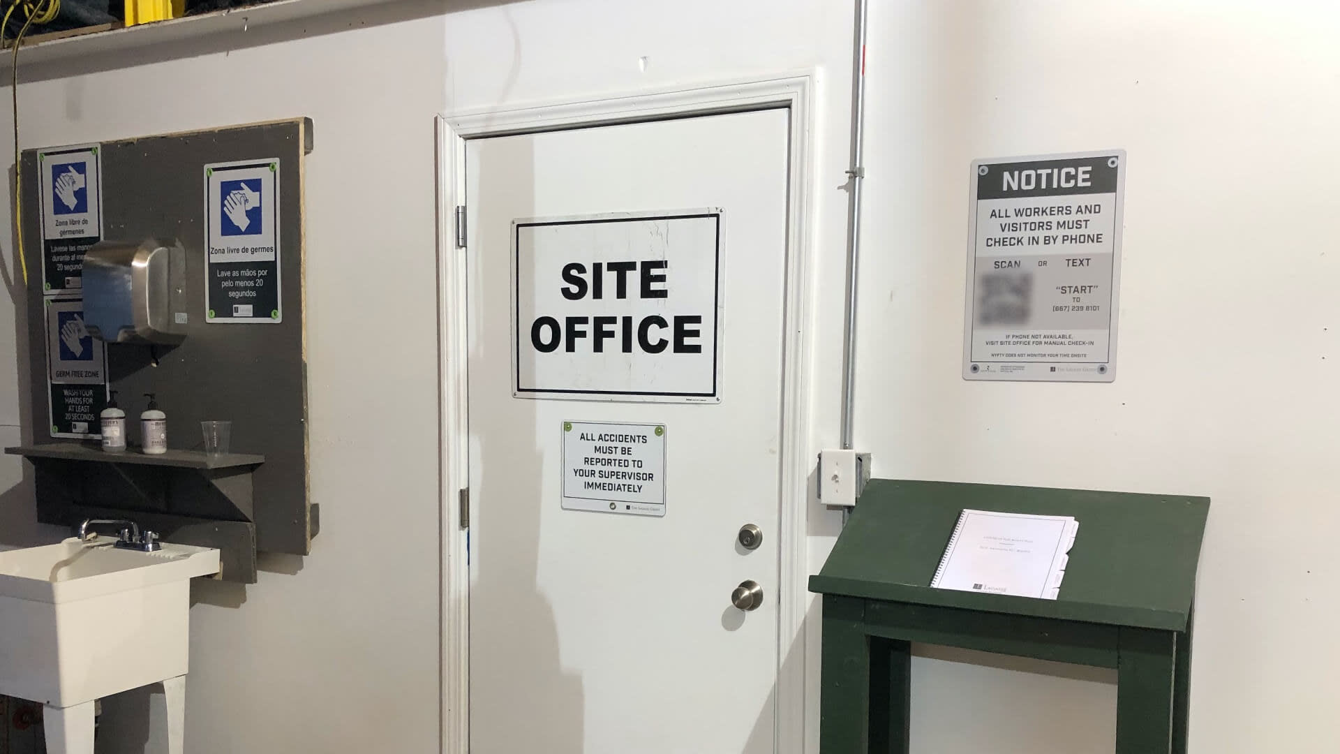 Doorway to site office with COVID-19 safety signs posted