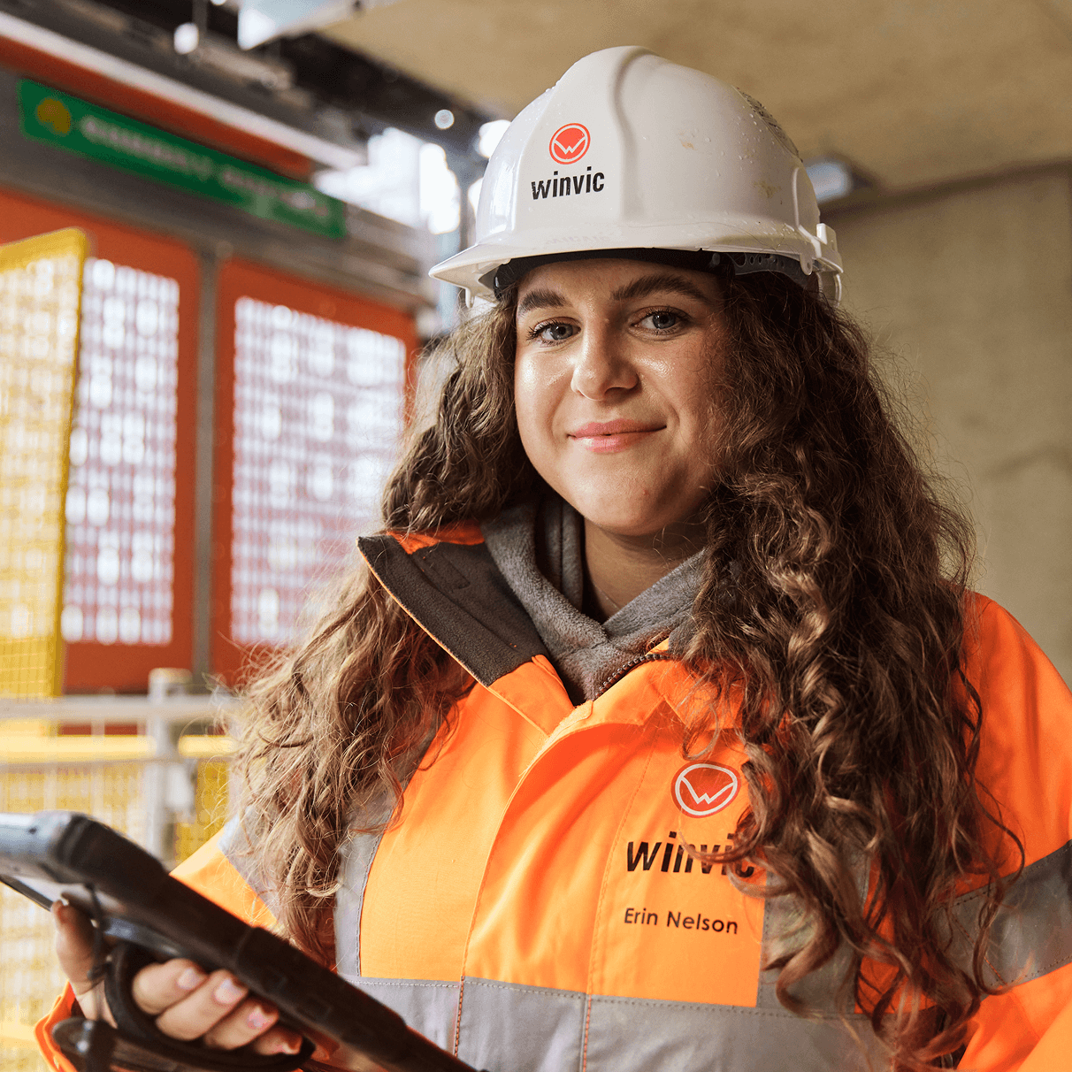 A woman construction worker wearing a safety outfit