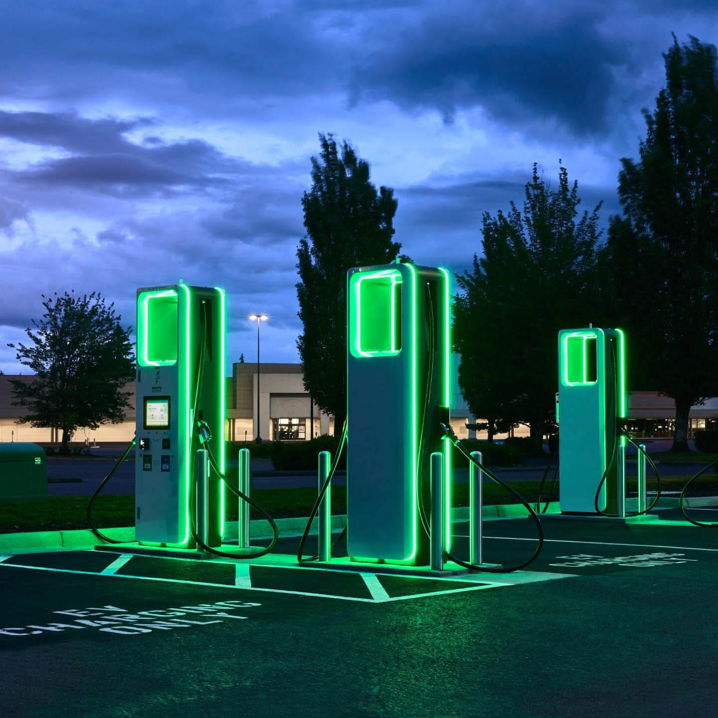 Darkened hero image of car chargers glowing at night