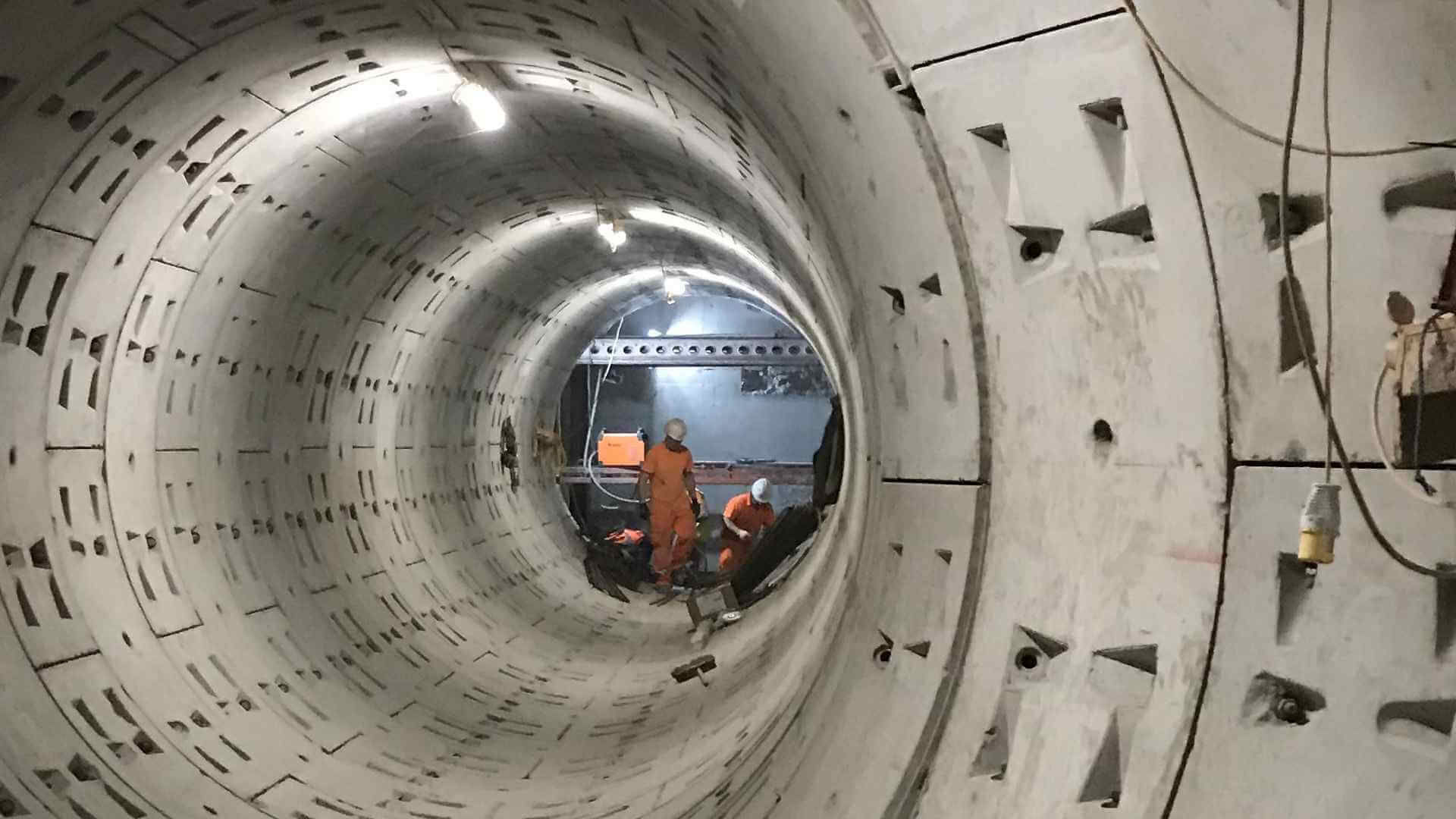 Construction workers working inside of a tunnel