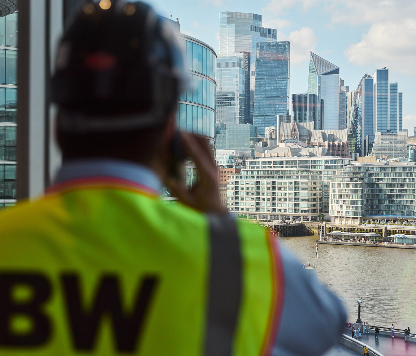 A construction worker holding a tablet on site