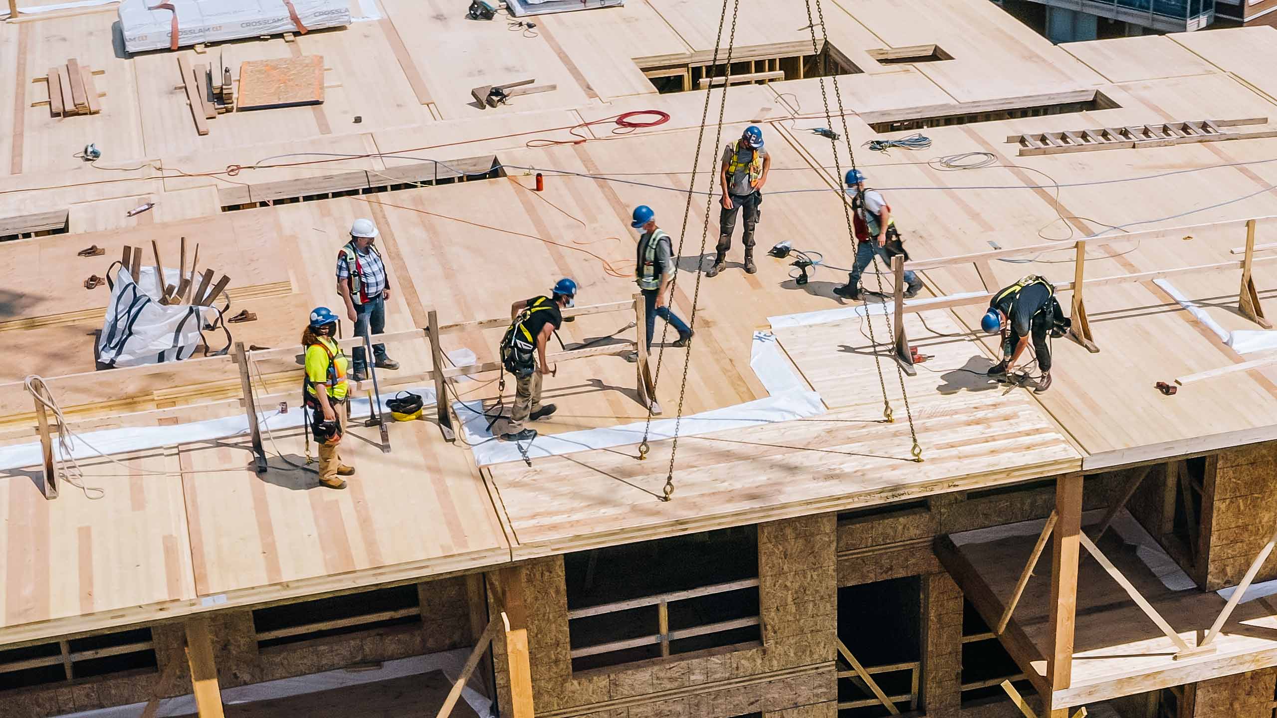 Construction workers on top of a building under construction