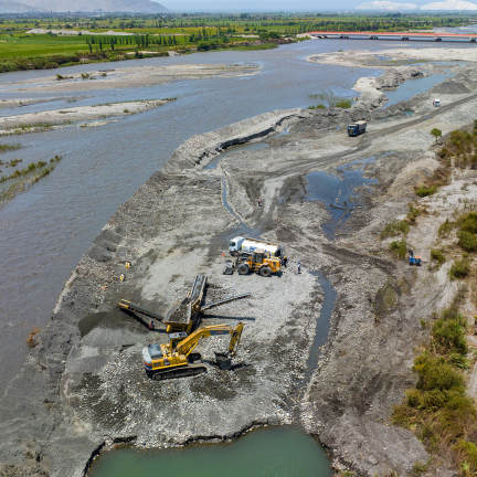 Construction machinery near a river