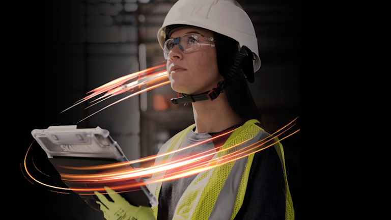 Construction worker reviewing plans on site