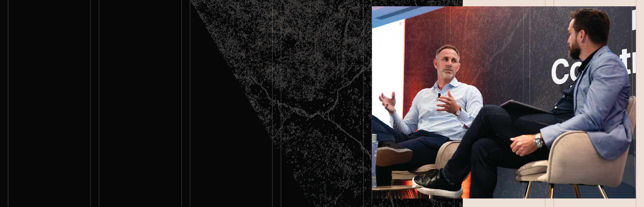 Two man having a conversation on a stage