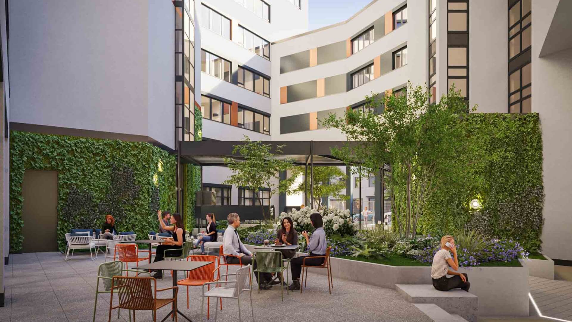 People sitting at tables in a courtyard