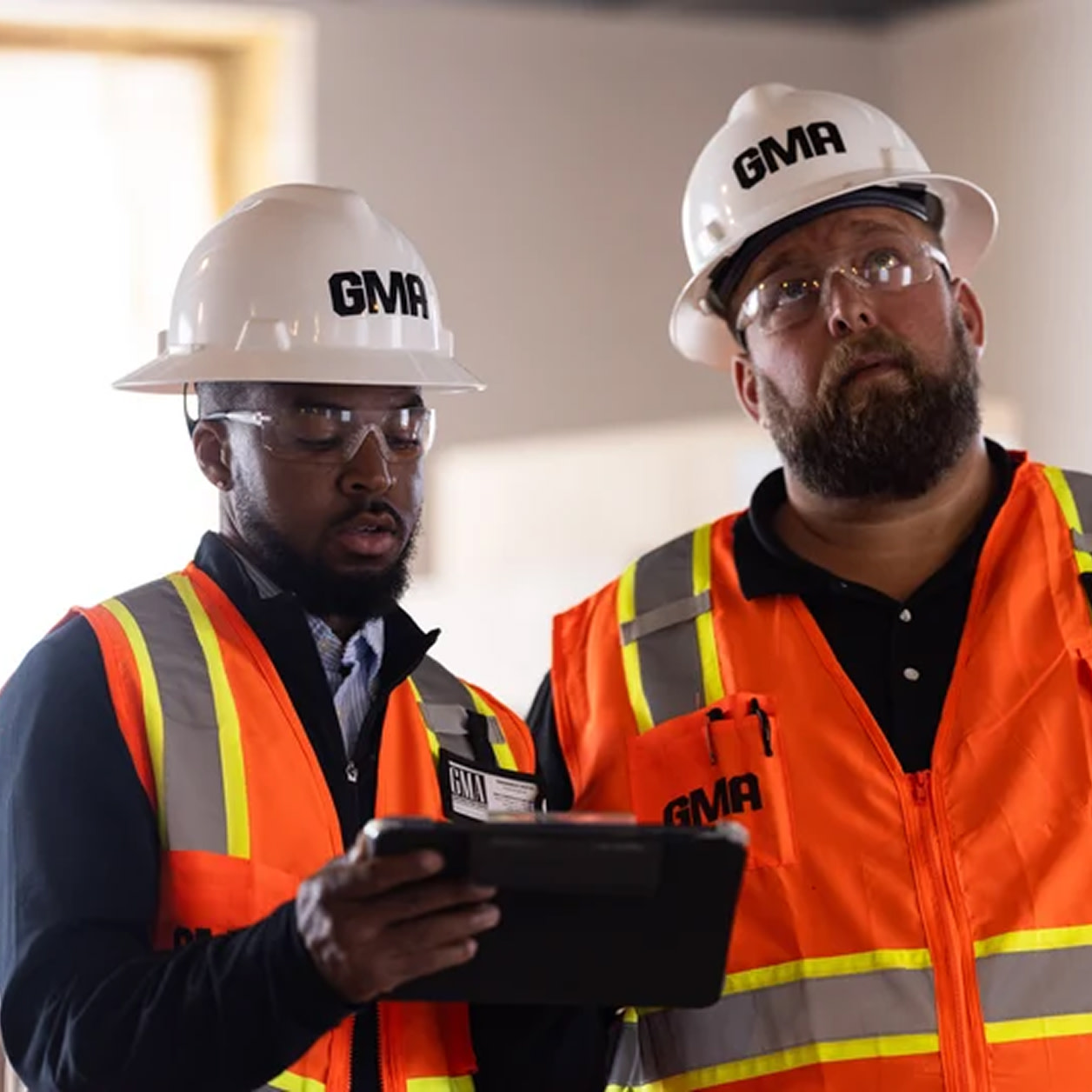 Two contractors inspecting a site