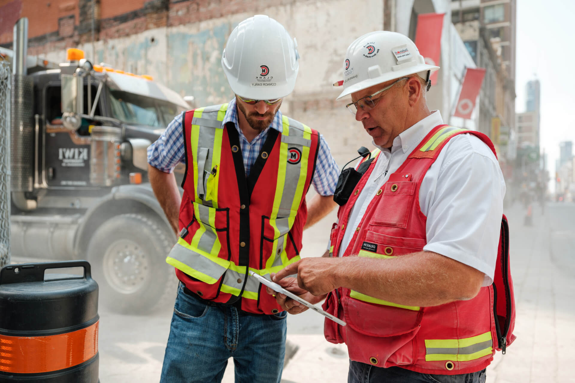 Contractors evaluating the project through Procore on a tablet