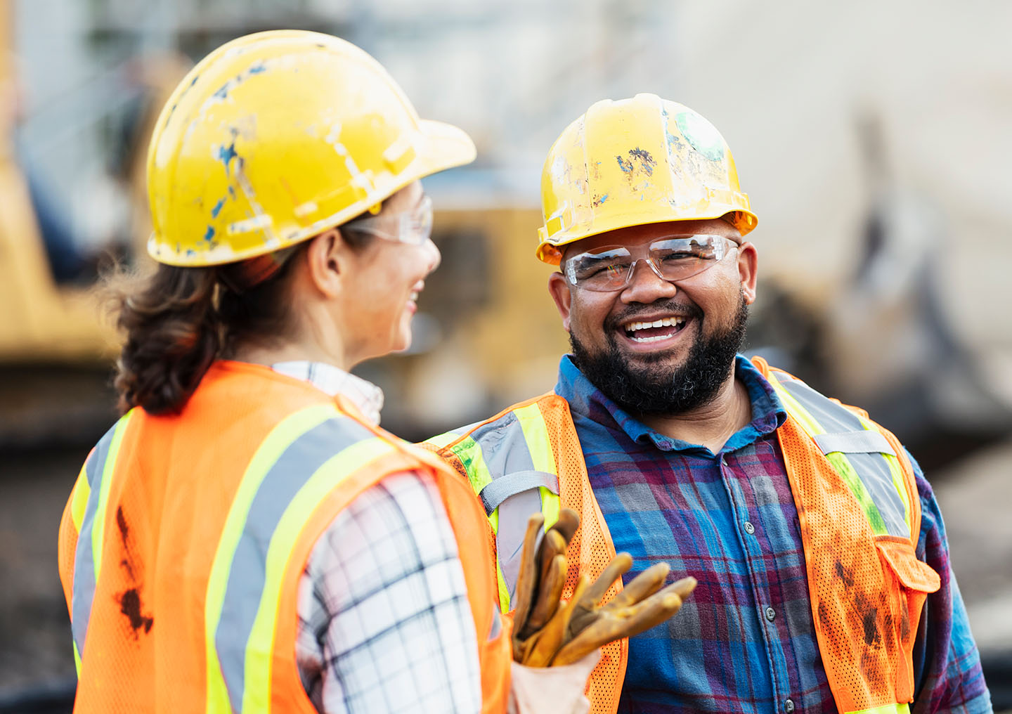 Two constructions workers laughing