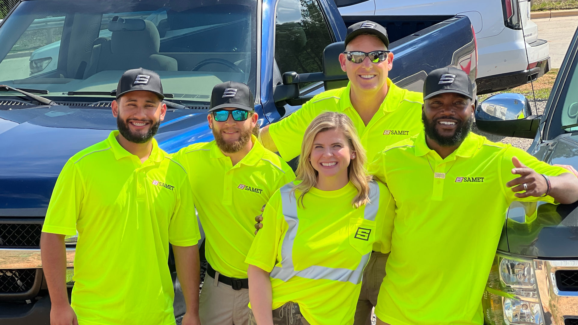 Samet workers smiling in a parking lot