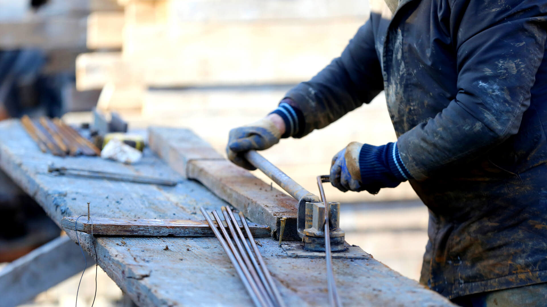 worker bending iron pipes